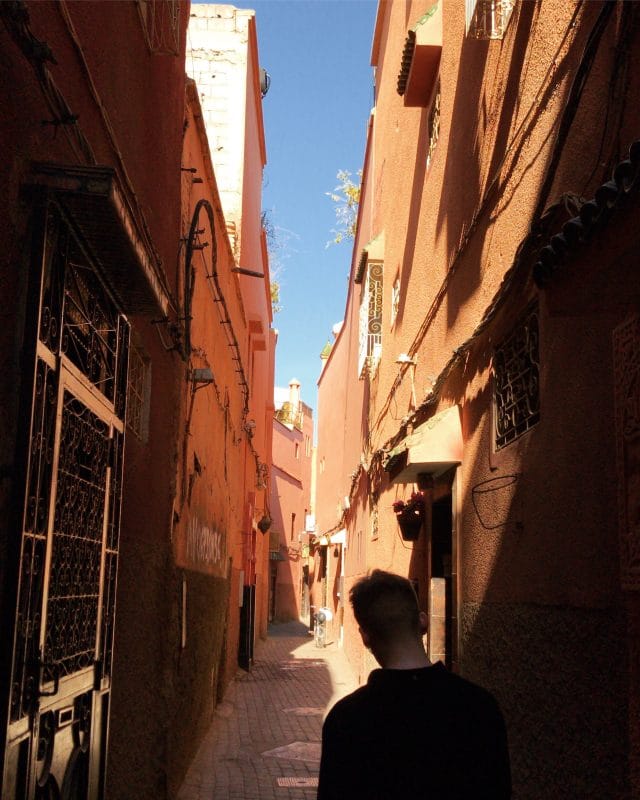 man walking in alleyway