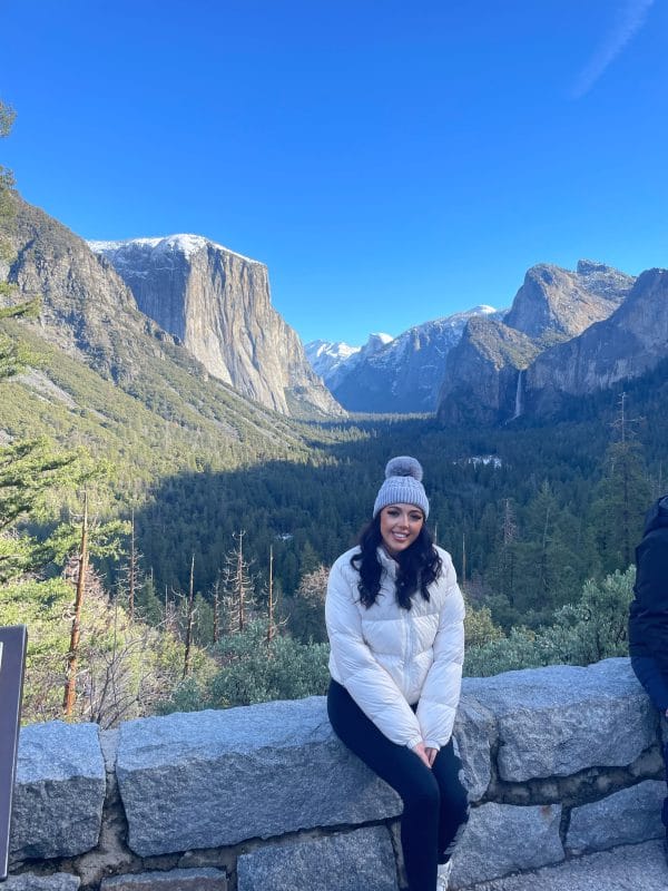woman with winter clothes with mountain with snow at the back