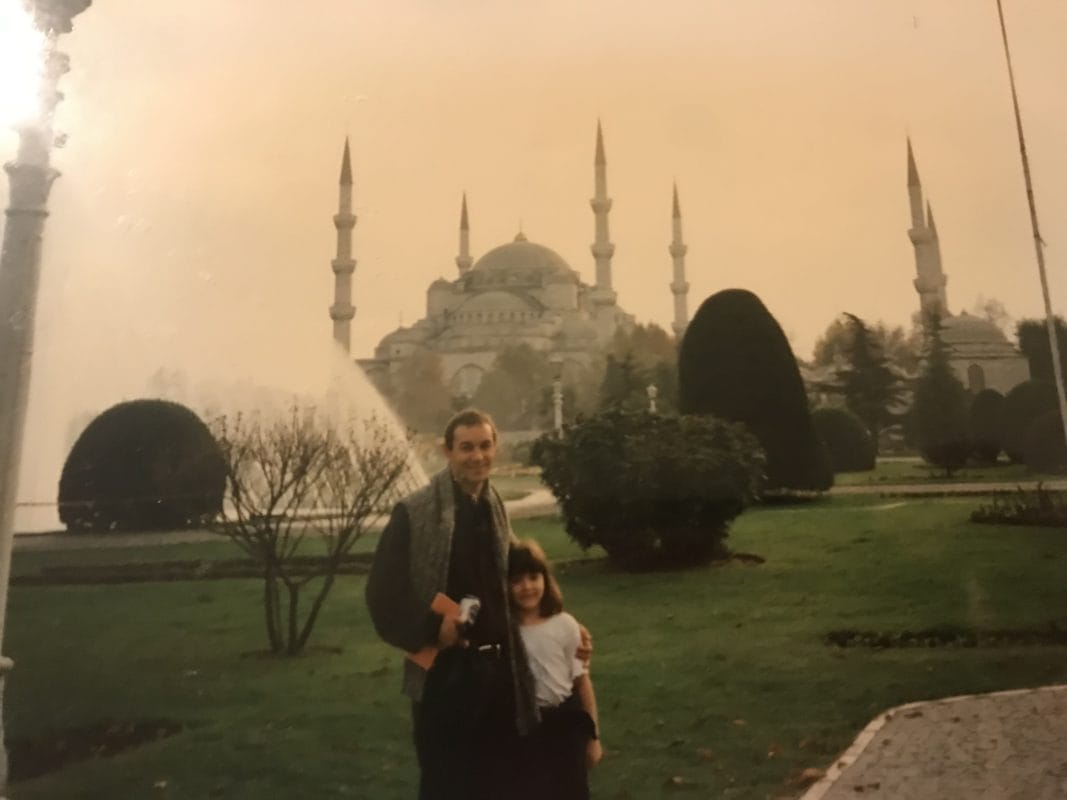 man and kid near white palace