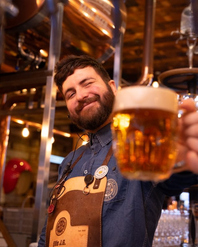 happy team member holding bear glass