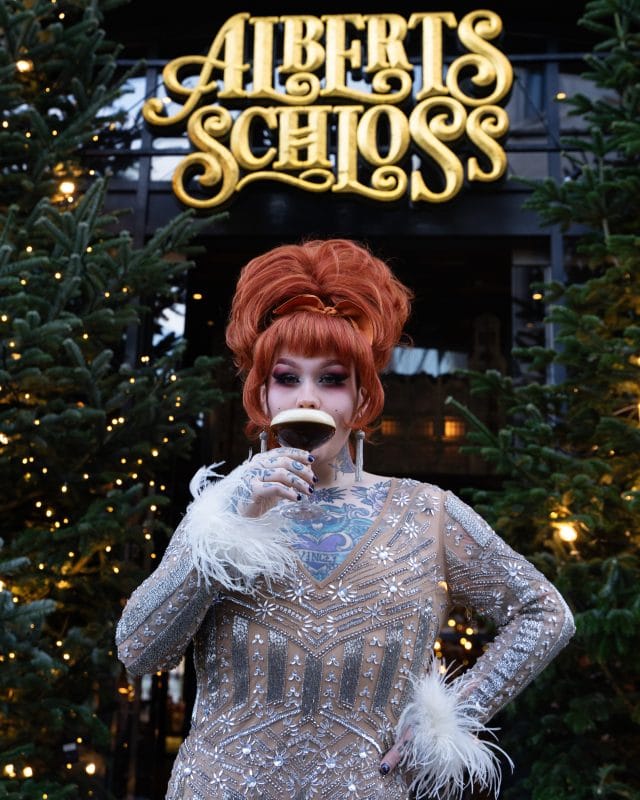 woman drinking cocktail outside restaurant