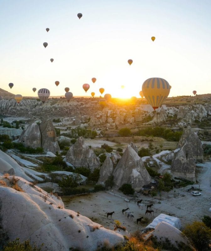 beautiful mountain view with sunset and hot air balloons