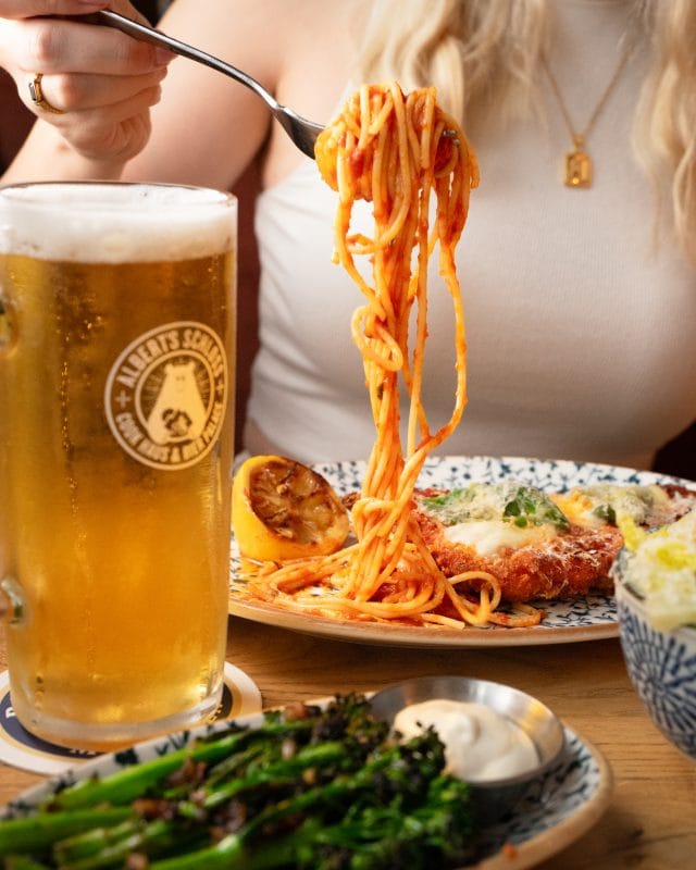 person eating pasta and alpine german food