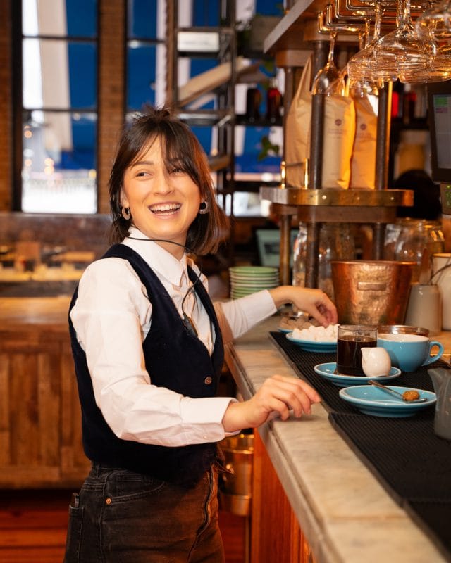 waiter smiling and preparing food service and coffee at the counter