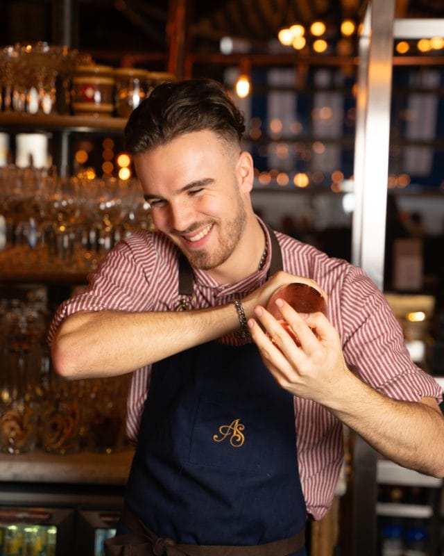 bartender at albert schloss preparing drink