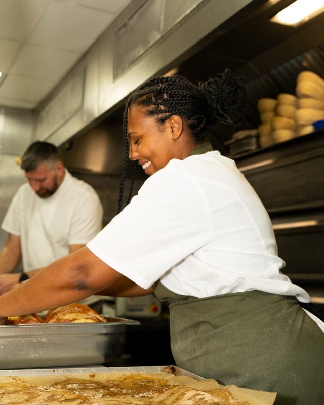 bakery staff preparing fresh pastry using trays