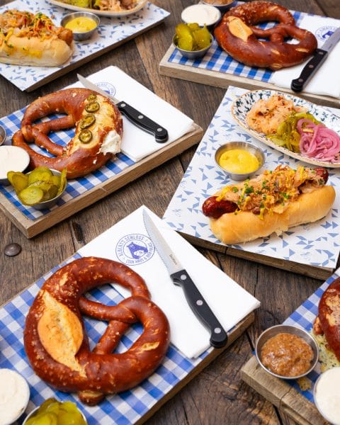 table with freshly baked pretzels and and hot dogs