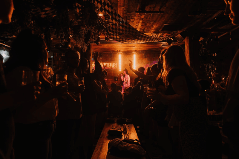 group of people drinking and listening to live music performance